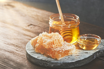 Honey background. Honey with wooden honey dipper on wooden table