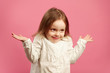 © Ilshat - Puzzled child shrugs her shoulders and raises hands, expresses ignorance or difficulty, does not know answer to the question.
