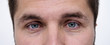 © malija - closeup of a man's bright blue eyes
