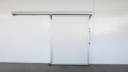 large freezer storage in the factory. closed door from warehouse