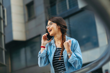 Young woman talking on the phone in the city