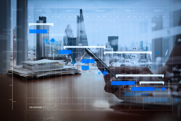 Wall Mural - double exposure of businessman hand use smart phone with office workspace