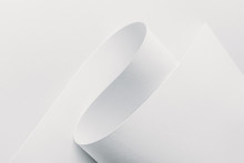 Close-up View Of White Rolled Paper On White Background