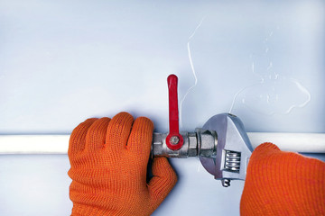 Wall Mural - A plumber fixes a water leak on a water pipe. Pepair plumbing background with copy space.