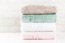 Spa Relax And Bath Concept, Stack Clean Bath Towels Colorful Cotton Terry Textile In Bathroom White Background, Copy Space Top View