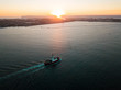 Aerial photo of a small tugboat at sunset