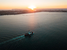 Aerial Photo Of A Small Tugboat At Sunset