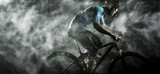 Cyclist cycling on mountain bike with rainy ,foggy on black background.
