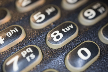 Modern black business landline telephone keypad buttons close-up.