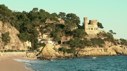 Wall Mural - Landscape of Lloret de Mar Castle and its beach in a sunny afternoon, Spain.