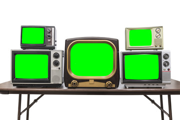 Wall Mural - Five vintage televisions isolated on white with chroma green screens and clipping path.