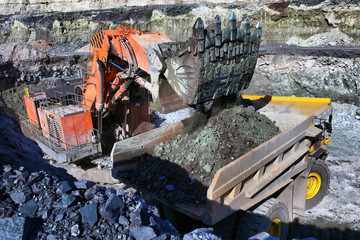 Wall Mural - Large quarry dump truck. Loading the rock in the dumper. Loading coal into body work truck.