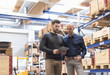 © Westend61 - Two men with tablet talking in factory storeroom