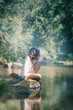 © g215 - woman sits on a rock on the shore of a lake