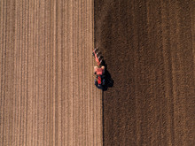 Aerial Shot Of A Farmer Plowing Stubble Field