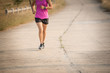 © nareekarn - Young lady running on a rural road during sunset, sports, healthy lifestyle