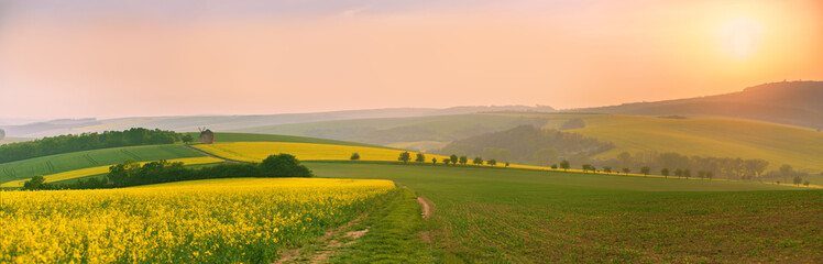 Old windmill at sunset. Spring landscape. Moravia fields panorama