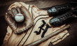 A group of vintage baseball equipment, bats, gloves, baseballsand a jersey on wooden background
