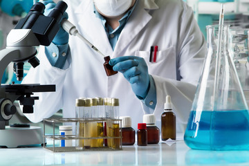 Wall Mural - researcher taking reactive with pipette for analysis in the research laboratory / scientist holding pipette and tube for taking samples mixed for tube test 