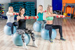 © kosmos111 - group session with a coach on the balls with dumbbells, shooting in the gym
