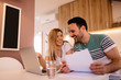 © Nebojsa - Happy young couple calculating bills at home while sitting in front of laptop