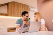 © Nebojsa - Happy young caucasian couple shopping online from home