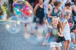 © travnikovstudio - Adorable little girl blowing soap bubbles in Trastevere in Rome, Italy