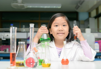Wall Mural - little scienctist making experiment in laboratory,