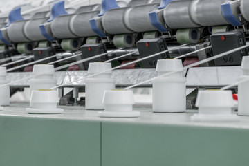 Canvas Print - Machinery and equipment in the workshop for the production of thread, close-up. interior of industrial textile factory