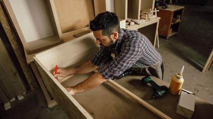 Wall Mural - handsome joiner work in carpentry. He is successful entrepreneur at his workplace.