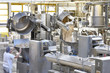 Arbeiter bedient Knetmaschinen in einer Großbäckerei - industrielle Herstellung am Fliessband von Brot in der Lebensmittelindustrie // kneading machines in a large bakery - food industry