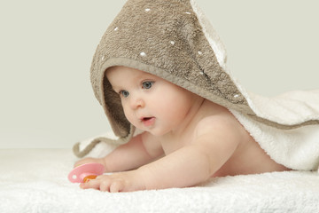 
Adorable baby covered with bath towel, studio shot