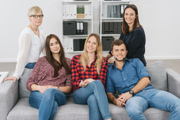 Wall Mural - Group of diverse friends relaxing on a sofa