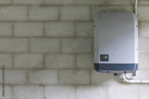 Fotografía Solar power inverter mounted on brick wall inside garage