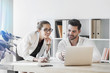 © PhotoPlus+ - Coworkers on a project working together on the same workstation, Communicate about technology, mobile devices, productivity, teamwork, applications, success, modern ways of staying productive.