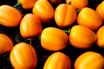 Wall Mural - Group of plastic fake yellow Bell peppers.