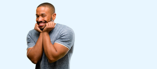 Poster - African american man with beard happy and surprised cheering expressing wow gesture isolated over blue background