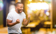 African american man with beard happy and excited celebrating victory expressing big success, power, energy and positive emotions. Celebrates new job joyful at night