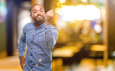 Poster - African american man with beard angry gesturing typical italian gesture with hand, looking to camera at night