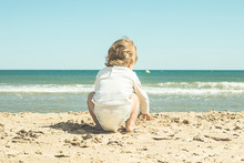 Little Girl With Diapers On The Beach .Child By The Sea