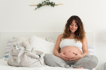 Wall Mural - Pregnant woman touching her belly