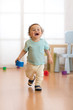 © Oksana Kuzmina - Cheerful baby toddler running in children room