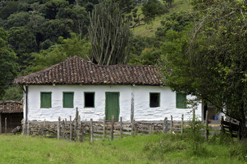 Old settler house in green landscape