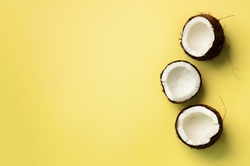 Wall Mural - pattern with ripe coconuts on yellow background. top view. copy space. pop art design, creative summ