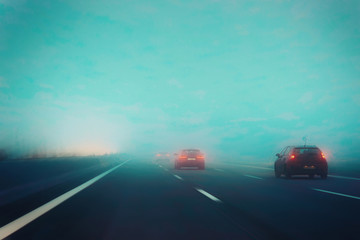 Fog in road with cars in evening