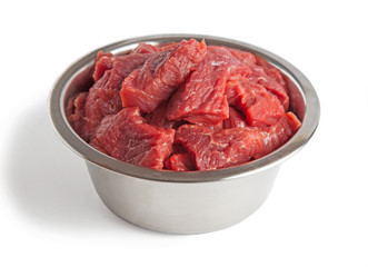 Raw beef meal in bowl, fresh, natural food for dog or cat, isolated on white background. 