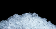 Pile Of Crushed Ice Cubes On Dark Background With Copy Space. Crushed Ice Cubes Foreground For Beverages.