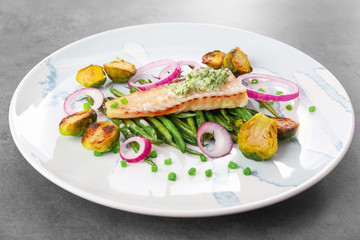 Sticker - Plate with tasty fish and vegetables on table