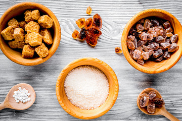 cooking sweets set with sugar in bowls on kitchen table backgrou