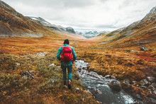 Traveling Man Tourist With Backpack Hiking In Mountains Landscape Active Healthy Lifestyle Adventure Vacations In Scandinavia